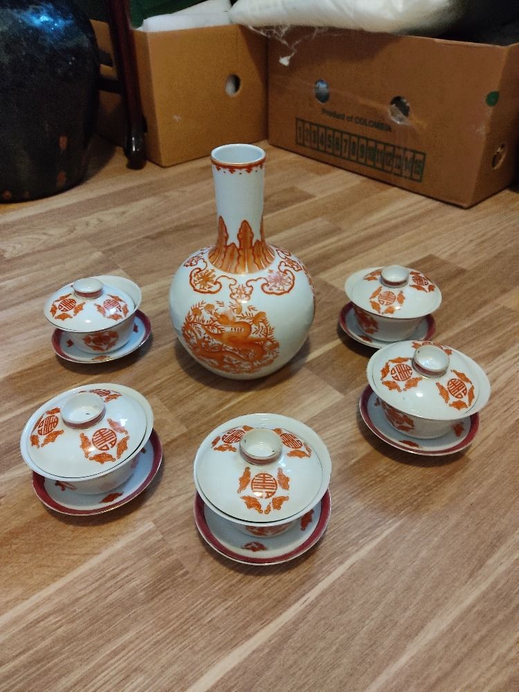 A set of five Chinese teabowls, covers and stands and a similar 'dragon' vase, 23cm